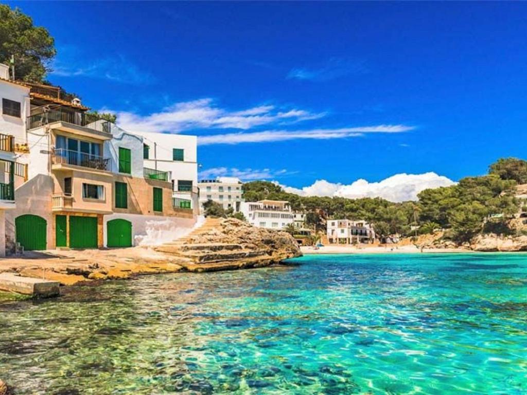 a view of a beach with buildings and the water at Villa Cala Santanyí Beach House JM by Interhome in Santanyi