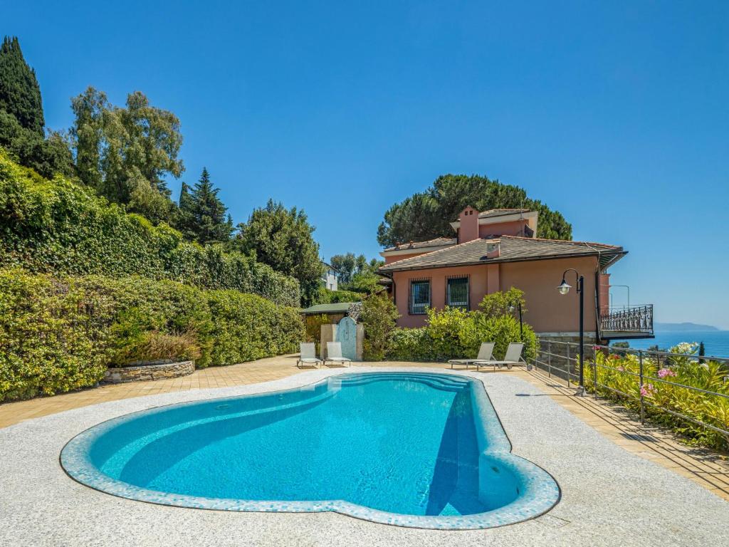 a swimming pool in front of a house at Apartment Casa del Leone II by Interhome in Rapallo