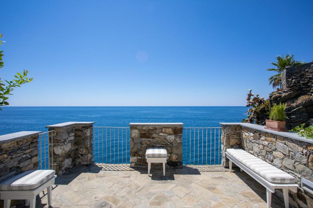 a patio with a view of the ocean at La Malà - camere di charme in Vernazza