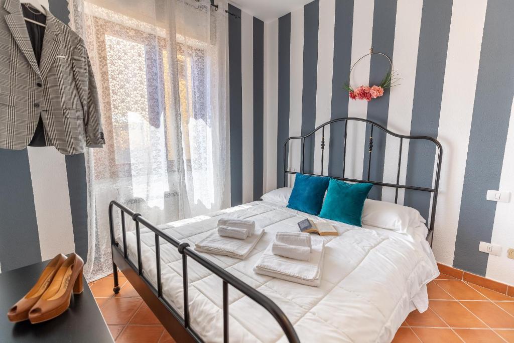 a bedroom with a bed with blue and white stripes at Montenero - B in Olbia