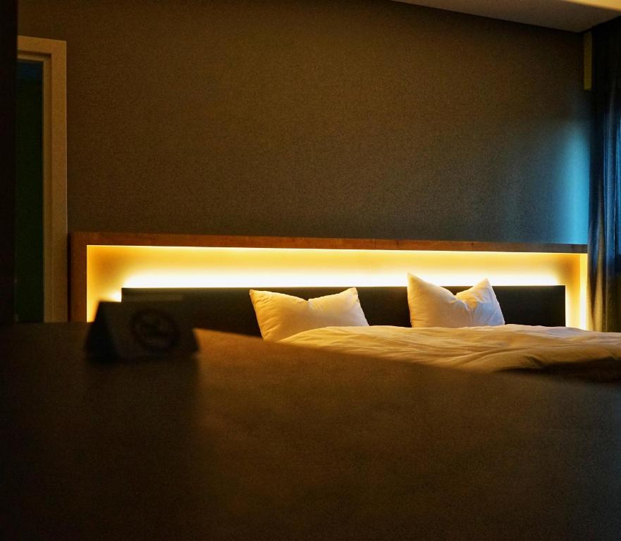 a bedroom with a bed with lights on it at House of Records in Munich