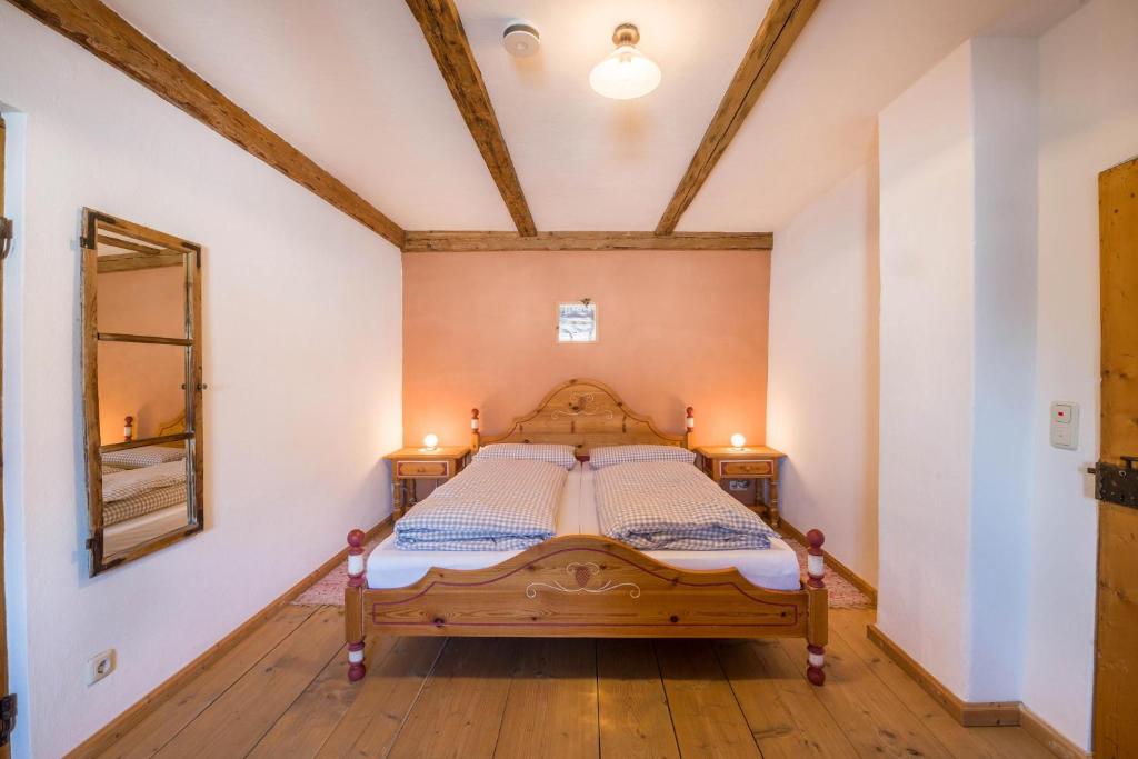 a bedroom with a wooden bed in a room at Ferienwohnung Gschwand in Unterammergau
