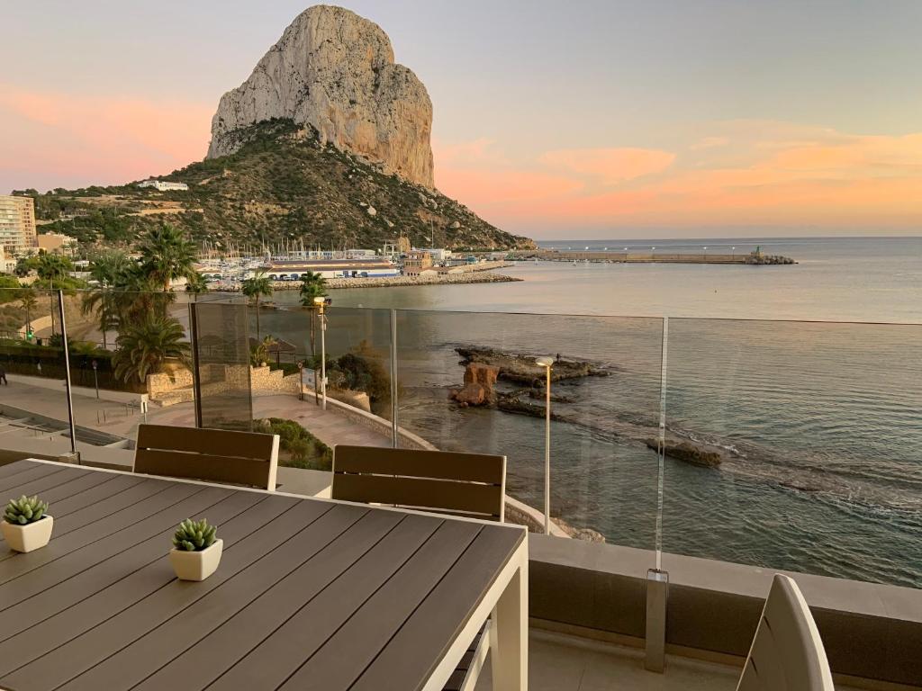 a balcony with a view of the ocean and a mountain at Apartamentos Maren in Calpe