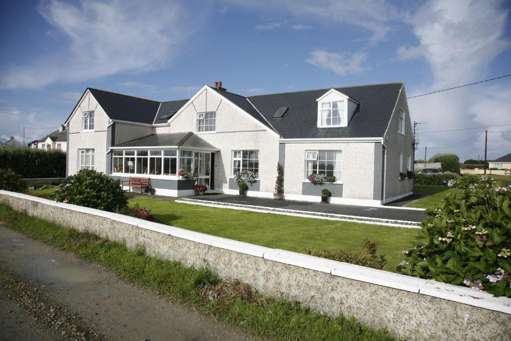 une maison blanche avec un toit noir dans l'établissement Bru Chlann Lir, à Belmullet