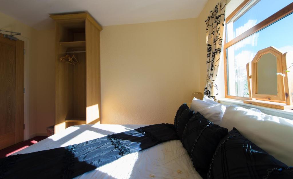 Postel nebo postele na pokoji v ubytování Aisleigh Guest House