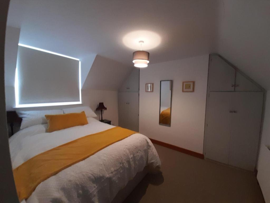 1 dormitorio con 1 cama con manta amarilla en Travellers Rest Apartment, en Beverley