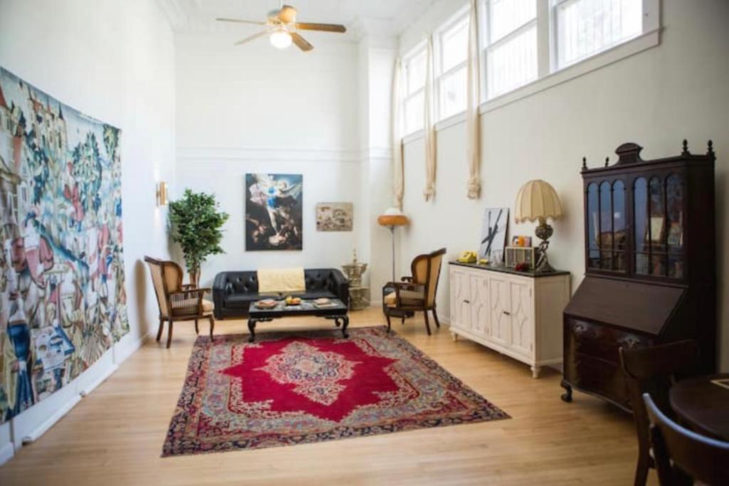 a living room with a couch and a red rug at Object Hotel - 1A Loft in Bisbee