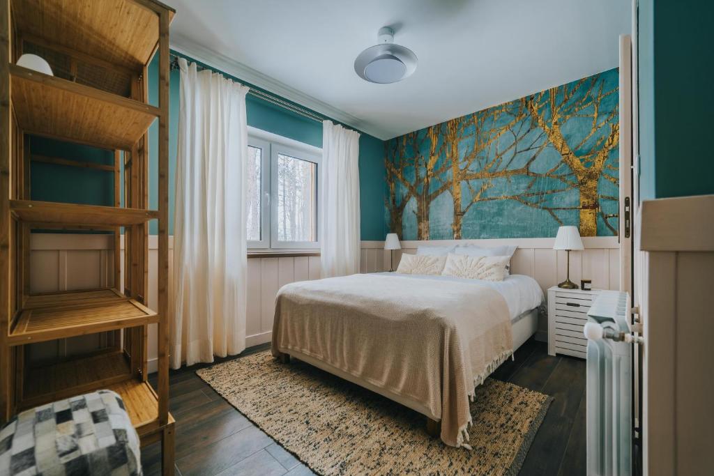 sypialnia z łóżkiem i obrazem na ścianie w obiekcie Sosnowy Taras w mieście Koszele