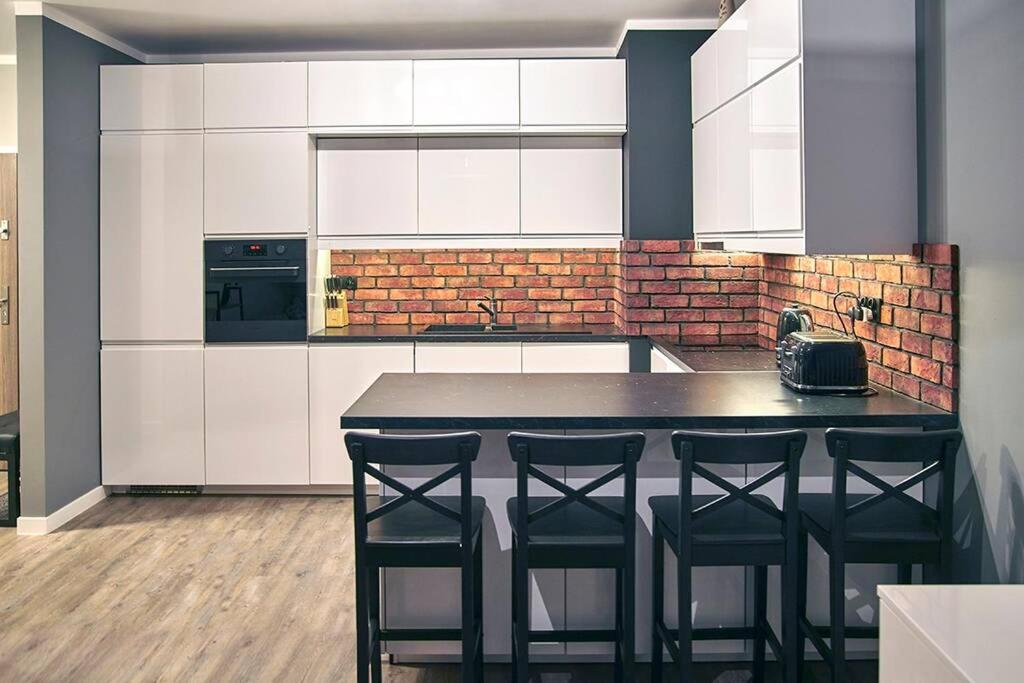A kitchen or kitchenette at Uroczy Apartament z Garażem