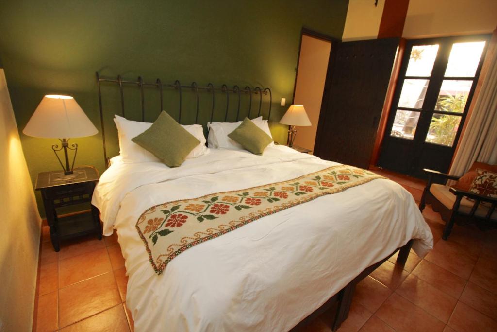 Postel nebo postele na pokoji v ubytování Casa Mia Suites