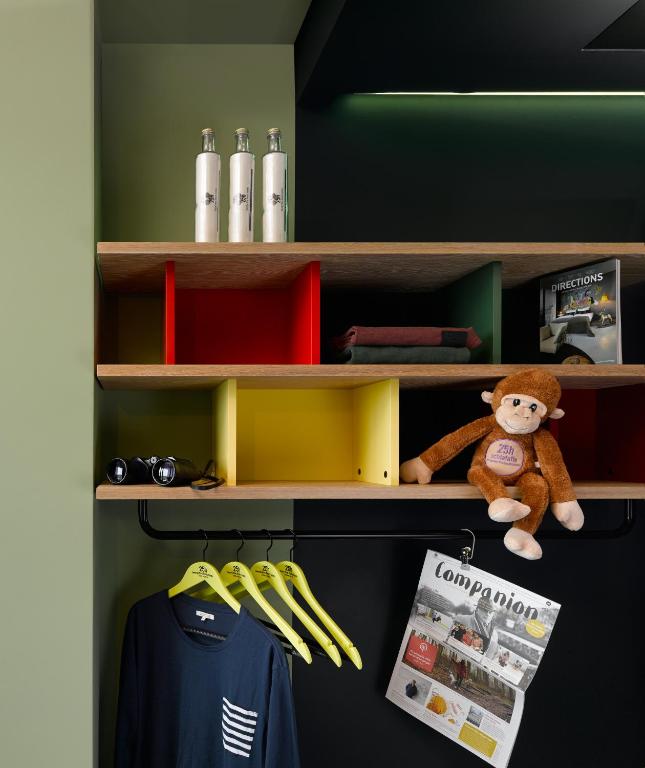 a shelf with a teddy bear sitting on it at 25hours Hotel Bikini Berlin in Berlin