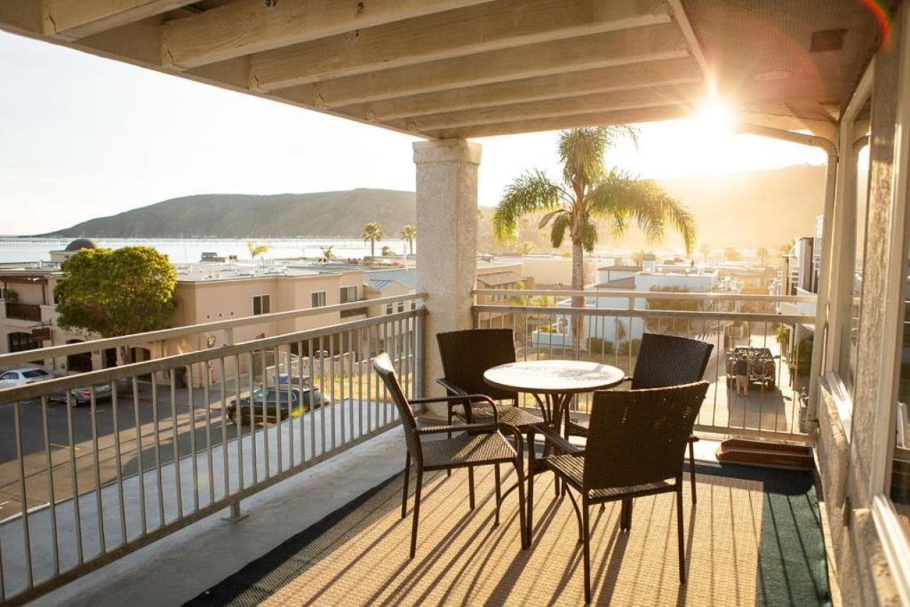 a balcony with a table and chairs and a view of the ocean at 90 San Luis Street Unit C in Avila Beach