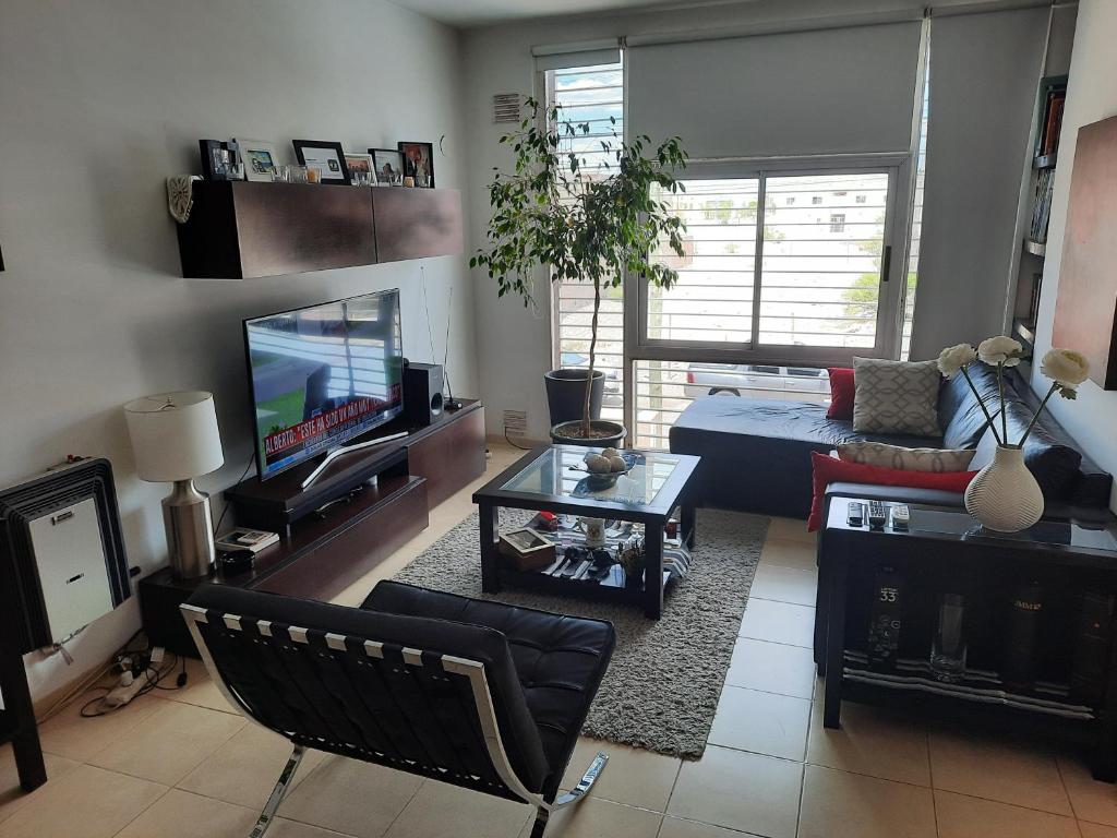 a living room with a couch and a tv at Departamento en San Juan, Argentina in San Juan