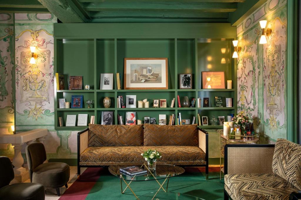 パリにあるオテル デ ドゥズィル ノートルダムの緑の壁のリビングルーム(ソファ付)