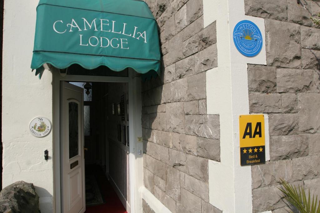 a building with a sign that reads camelia lodge at Camellia Lodge Guest House in Weston-super-Mare