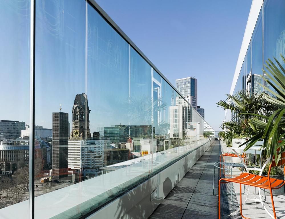 a balcony with a view of a city skyline at 25hours Hotel Bikini Berlin in Berlin