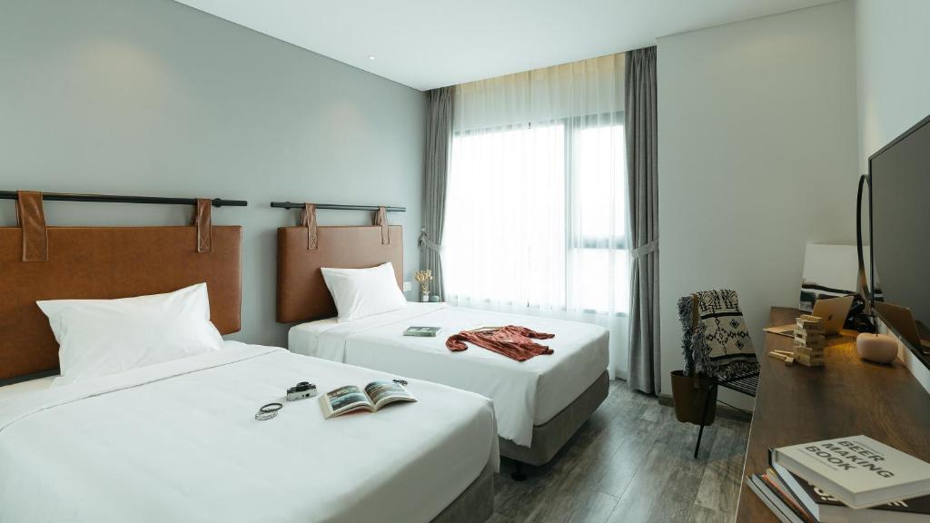 Postel nebo postele na pokoji v ubytování Em Oi Boutique Hotel