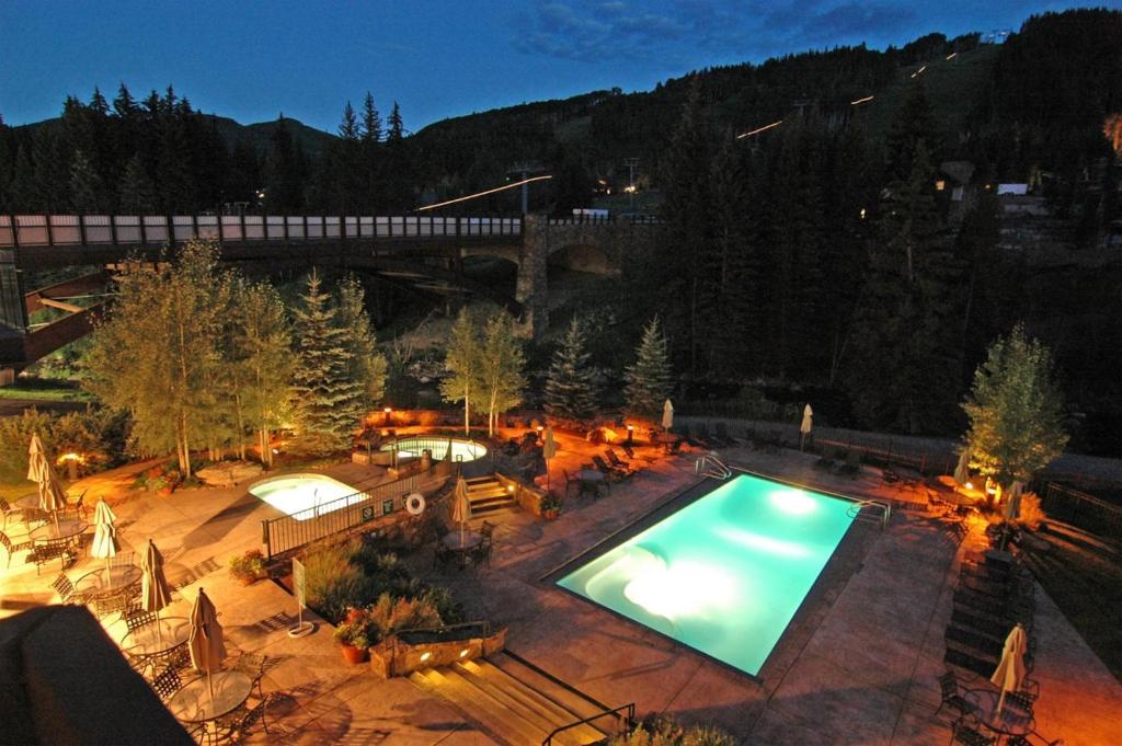 an overhead view of a swimming pool at night at Ski In, Ski Out Studio Condo In The Heart Of Lionshead Village With Hot Tub And Pool Access in Vail