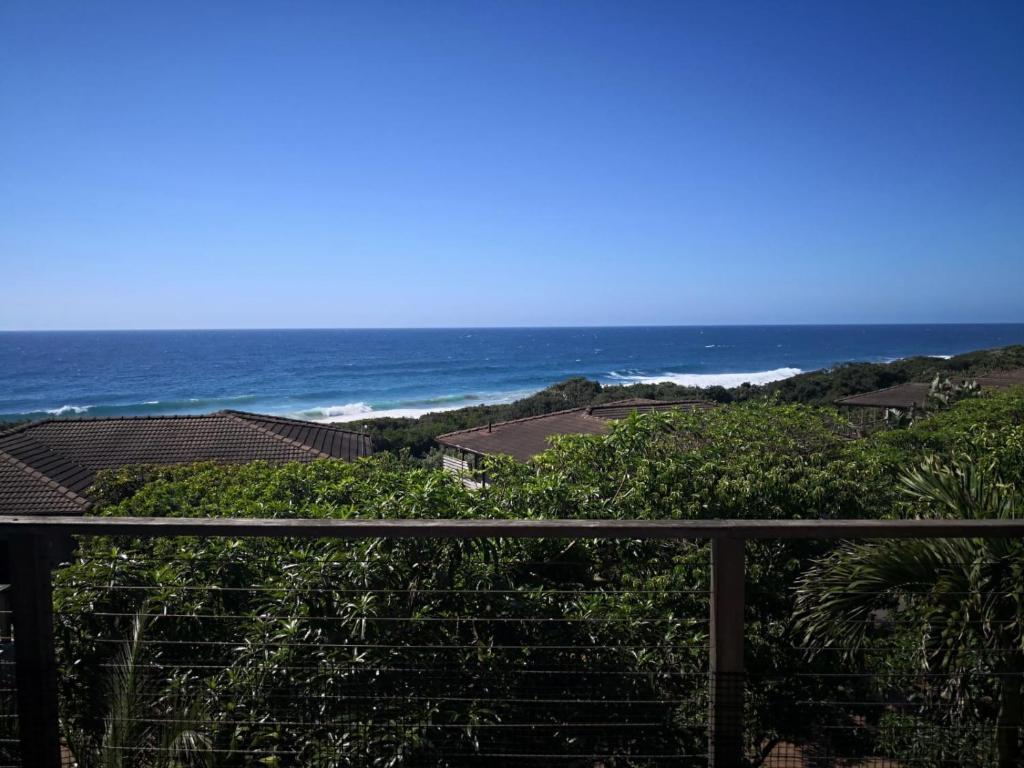 a view of the ocean from a balcony at Blissful Beachfront Apartment - 11 Sovereign sands in KwaDukuza