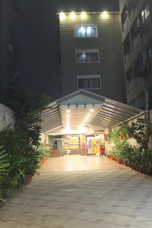 a building with a lit up entrance at night at Hotel Kanak in Ahmedabad