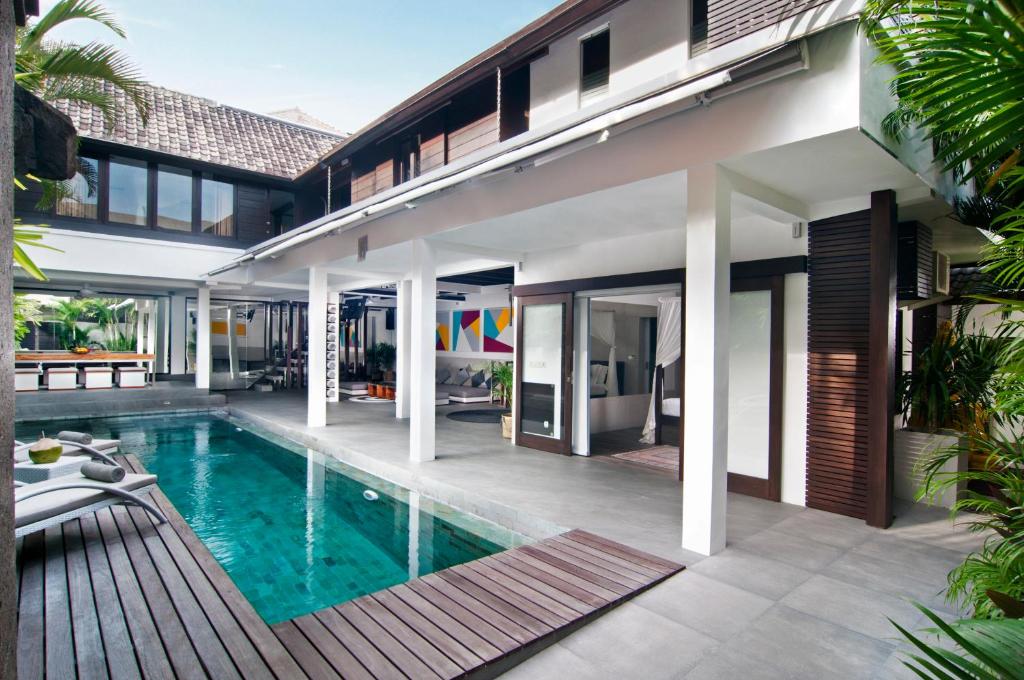 an external view of a house with a swimming pool at 5BR Villa Sabtu - Minggu Villas Seminyak in Seminyak