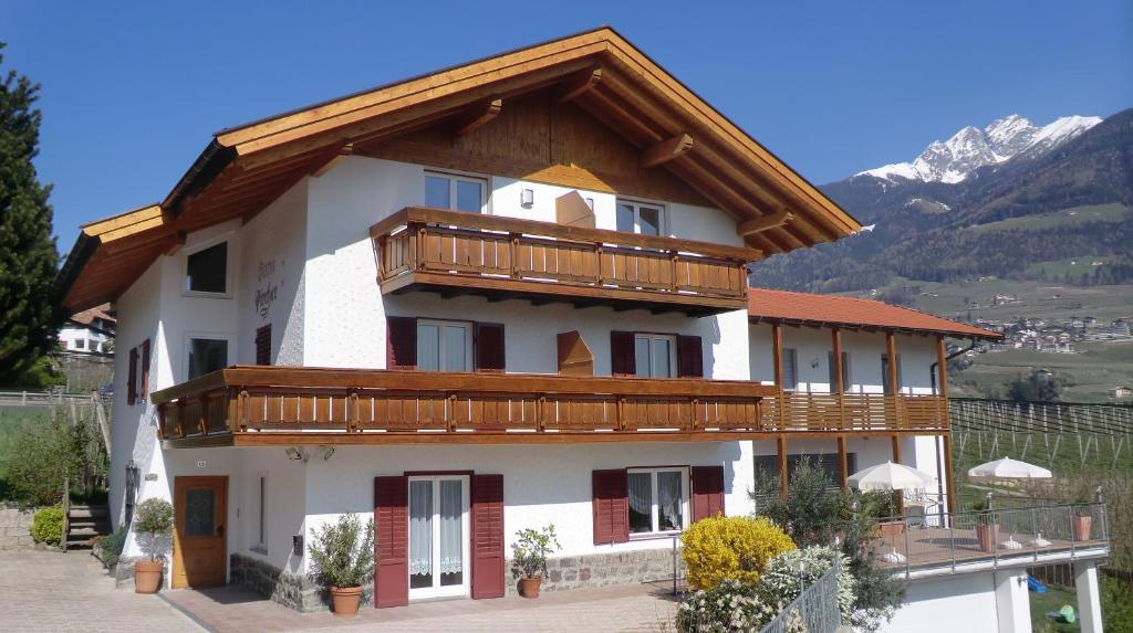 a building with a balcony on top of it at Garni Pircher in Tirolo