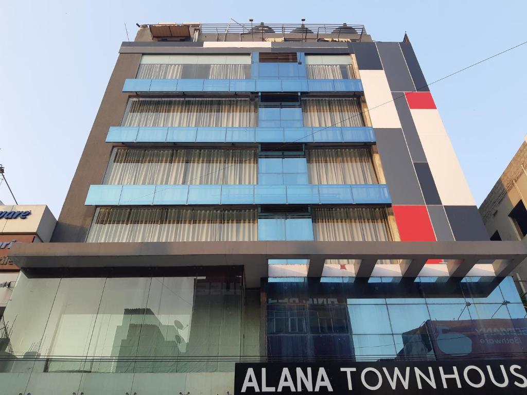 a tall building with a sign in front of it at Alana Townhouse in Vijayawāda