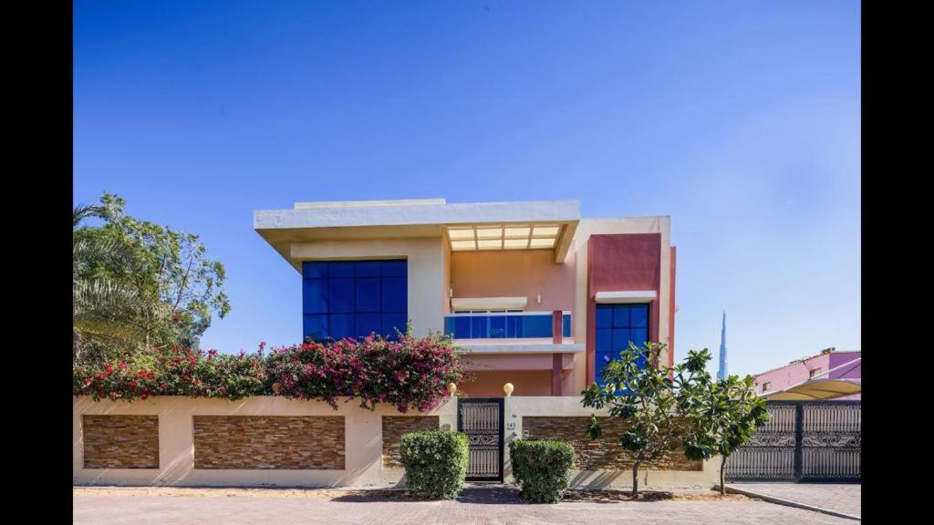 a house with flowers on the side of it at Hometown Apartments - Incredible 4 Bedroom plus maidsroom Villa in Dubai