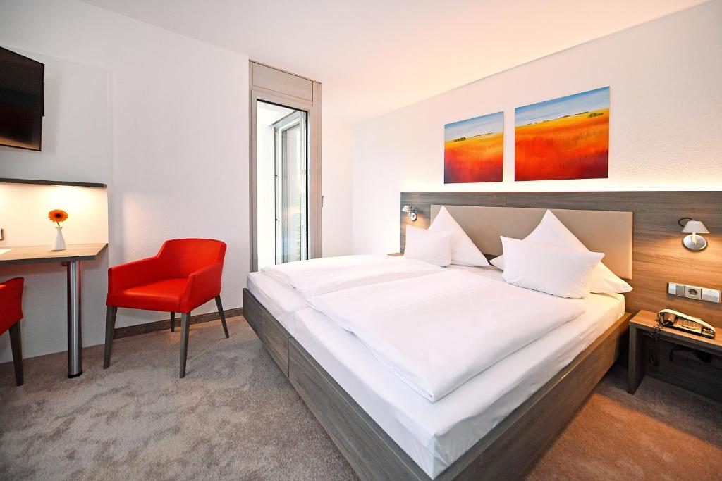 Ein Bett oder Betten in einem Zimmer der Unterkunft GenoHotel Karlsruhe