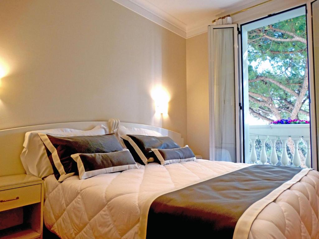Postel nebo postele na pokoji v ubytování Novecento Suite Hotel