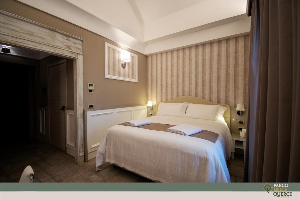 Postel nebo postele na pokoji v ubytování Hotel Parco delle Querce