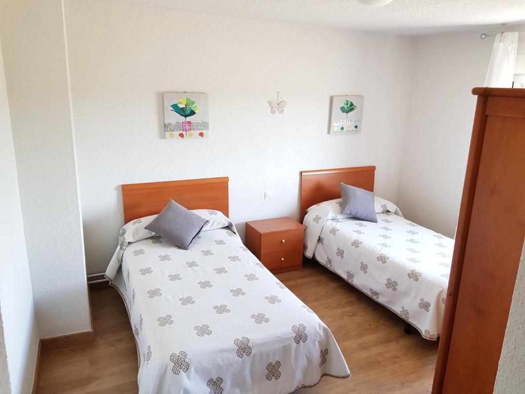 Posteľ alebo postele v izbe v ubytovaní Vivienda Turística El Asturiano