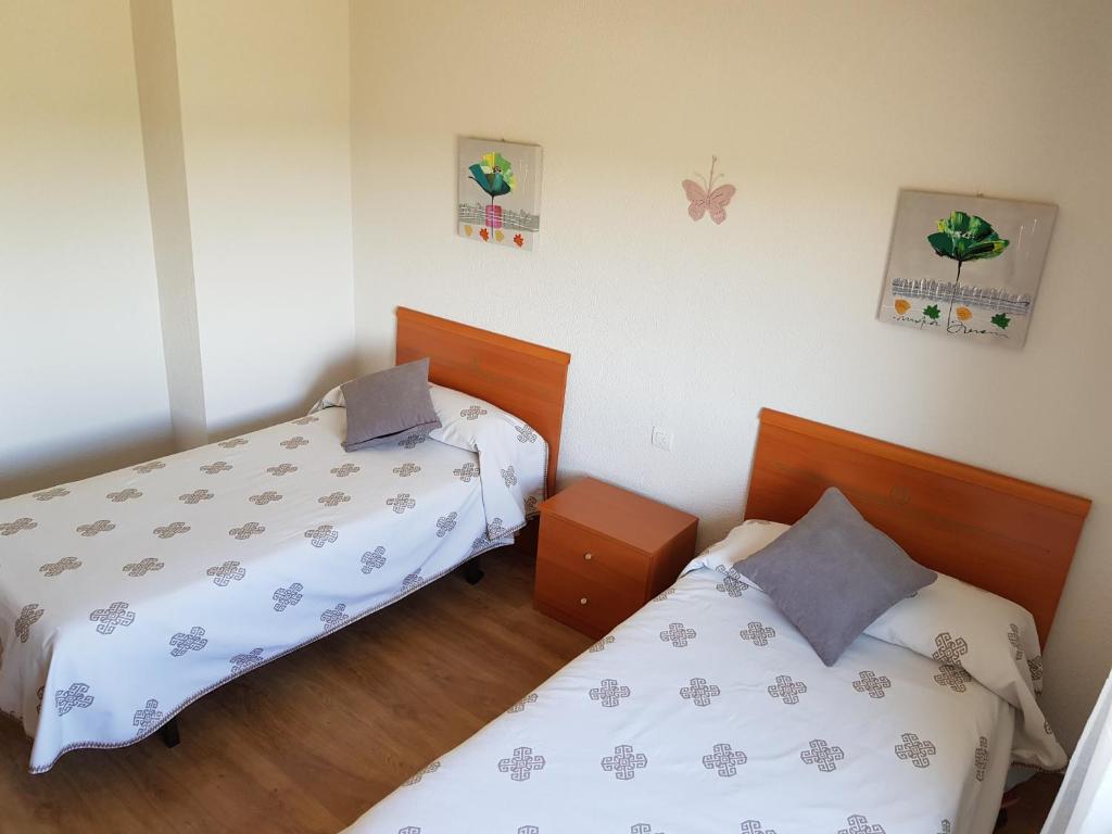 Posteľ alebo postele v izbe v ubytovaní Vivienda Turística El Asturiano
