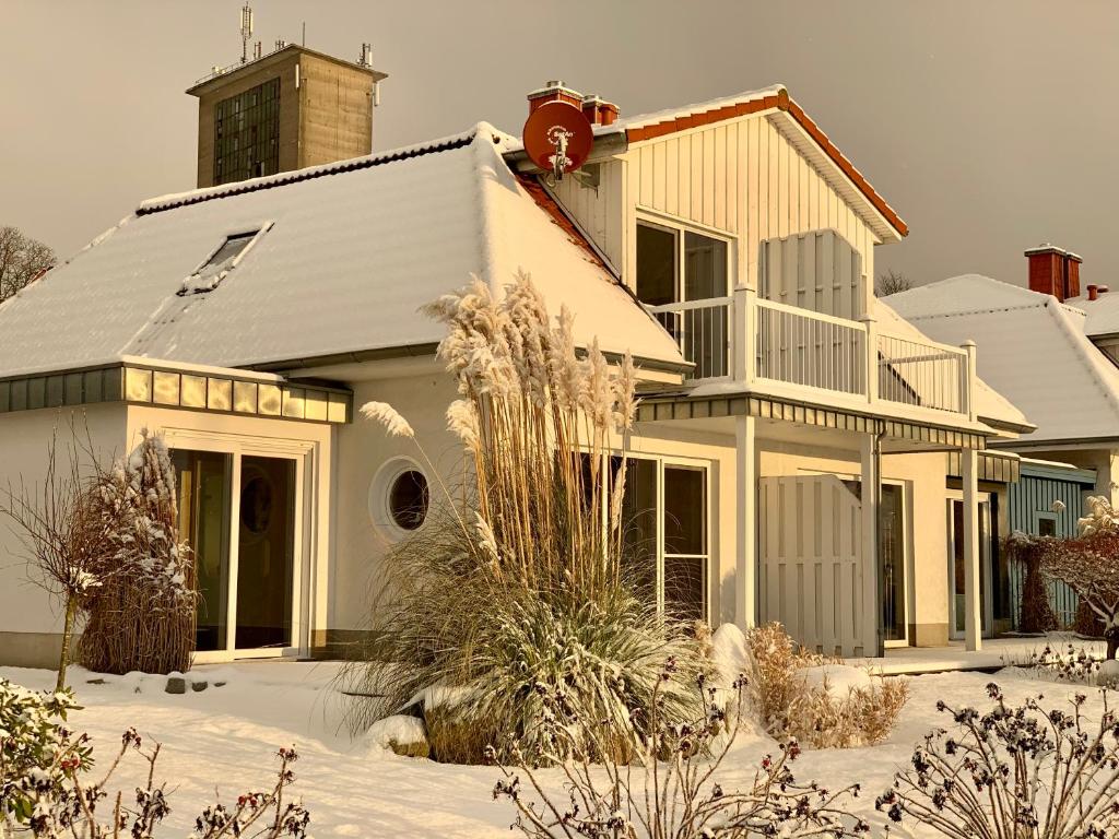 a house with snow on the ground in front of it at Fischerhus in Bad Kleinen