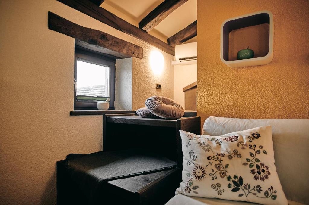 a room with a bed and a tv on the wall at Tmbin's barn - nature, horses, family in Sežana