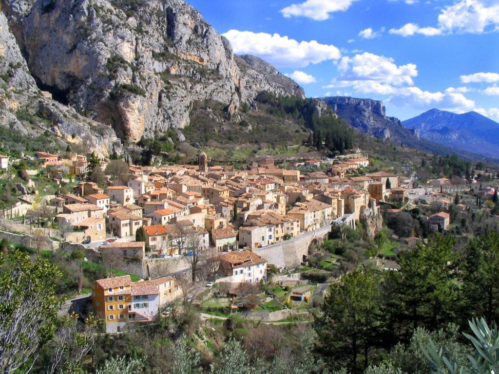 a view of a town in the mountains at Camping Le Saint Clair in Moustiers-Sainte-Marie
