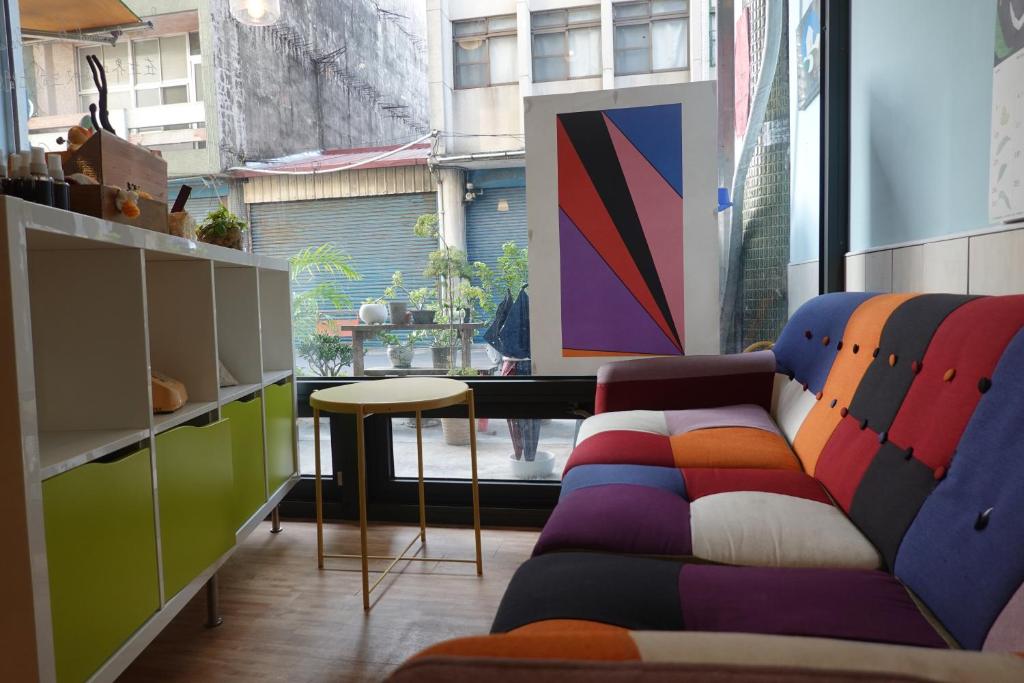 a living room with a couch and a table at Center.Center Hostel in Puli