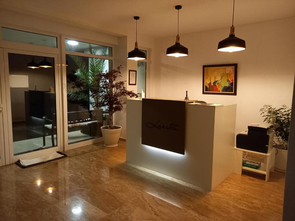 a lobby with a reception desk and potted plants at Relax Larrisa Studio in Primorsko