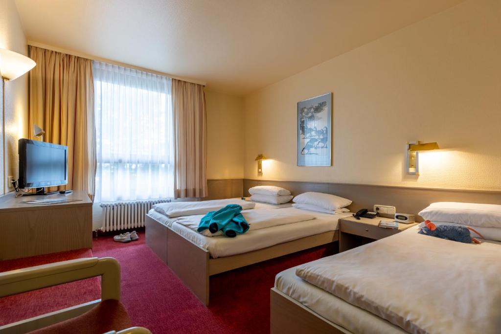 Postel nebo postele na pokoji v ubytování Hotel Baden-Baden