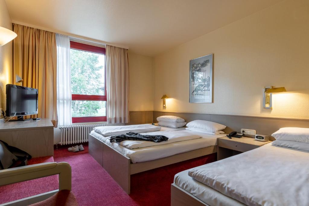 Postel nebo postele na pokoji v ubytování Hotel Baden-Baden