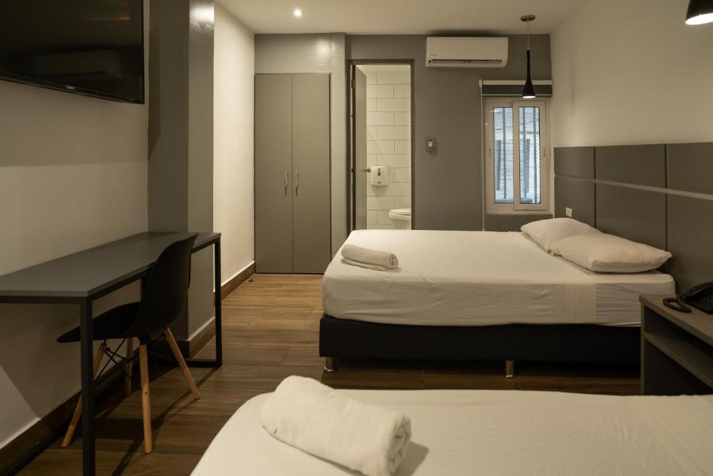 Postel nebo postele na pokoji v ubytování Residencial & Hotel Palazzo
