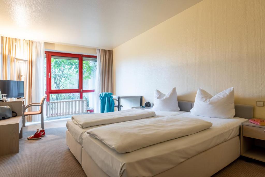 Postel nebo postele na pokoji v ubytování Hotel Baden-Baden