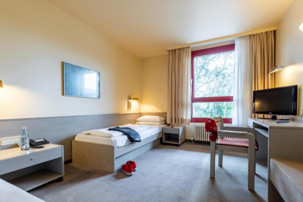 Postel nebo postele na pokoji v ubytování Hotel Baden-Baden