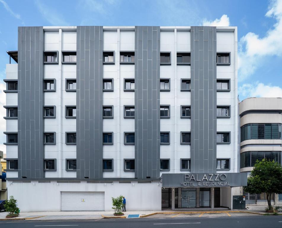 a large white building with a sign on it at Residencial & Hotel Palazzo in Panama City