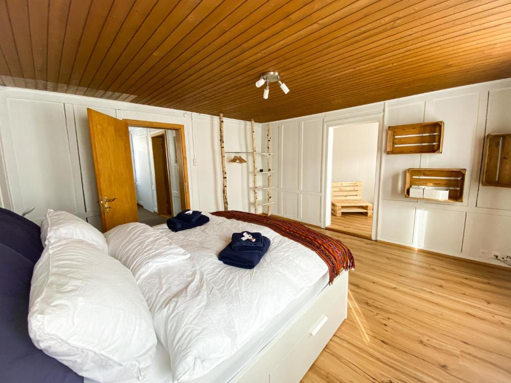 a bedroom with a large bed with blue towels on it at Naturaleza Pura in Urnäsch