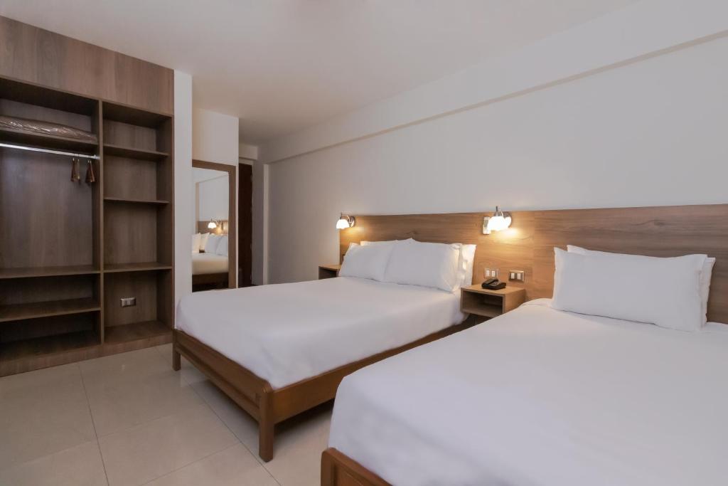 Postel nebo postele na pokoji v ubytování Hotel Alexander