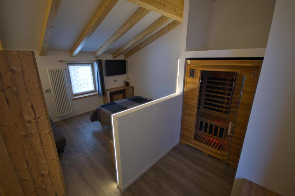 Televízia a/alebo spoločenská miestnosť v ubytovaní B&B Paganella Relax and Gourmet