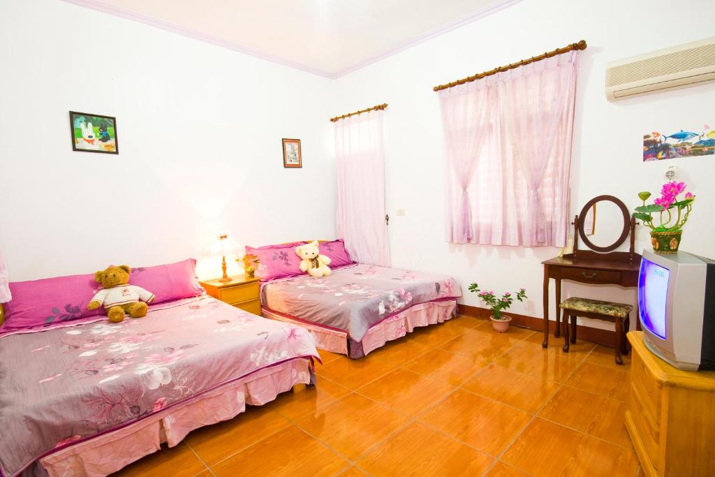 Postel nebo postele na pokoji v ubytování Yilan Xiang Feng Homestay