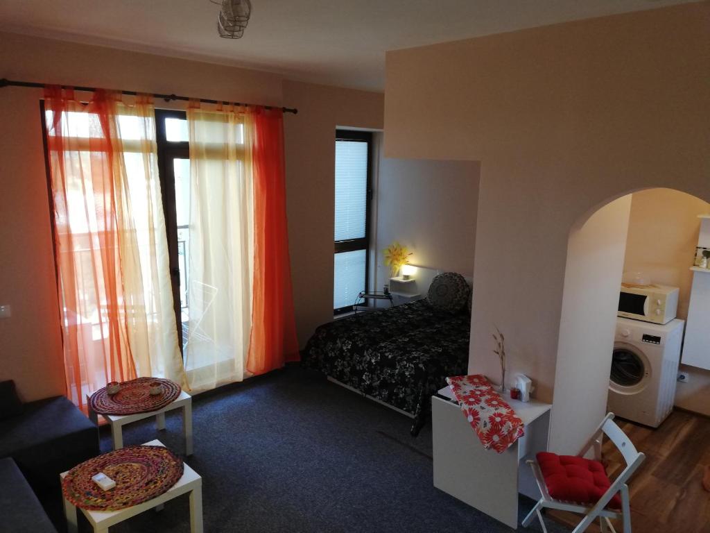a room with a bed and a living room at студио Маргрете in Burgas City