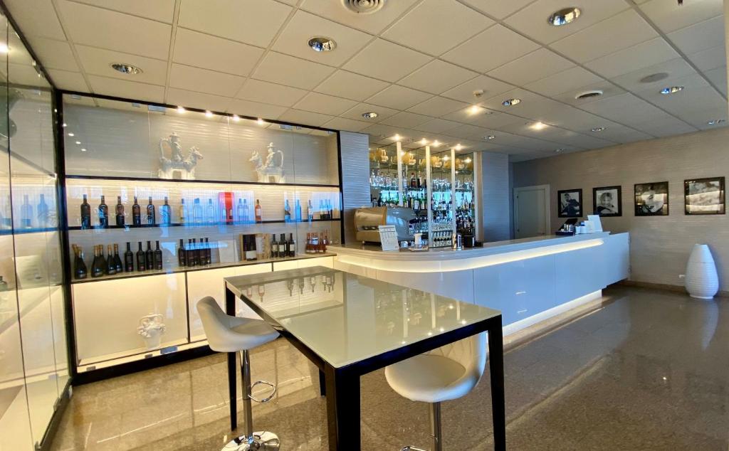 a restaurant with a glass table and two chairs at Barion Hotel & Congressi in Bari